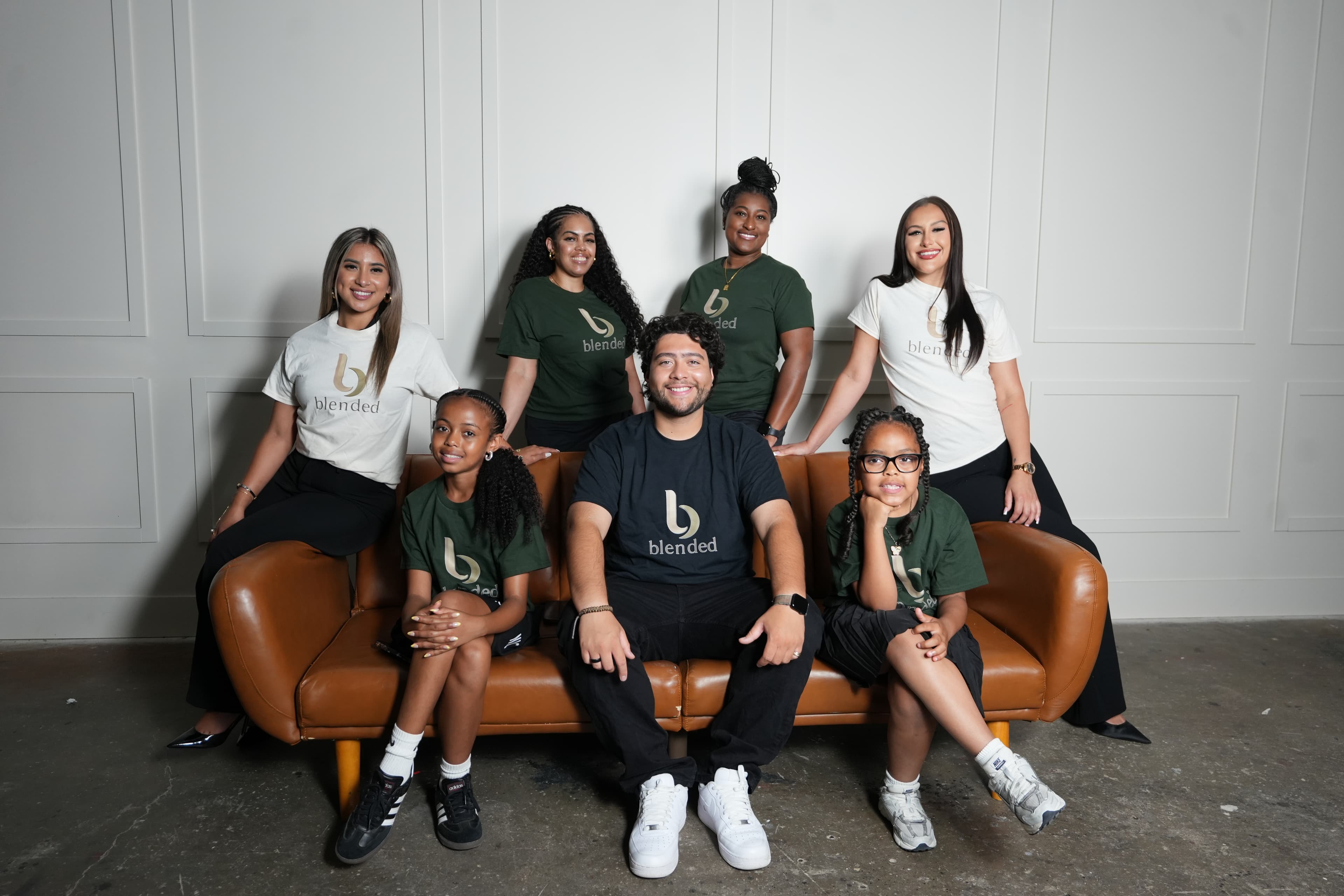 Blended team gathered together on a studio couch